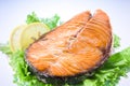 Salmon steak with salad and lemon Royalty Free Stock Photo