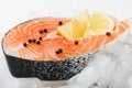 Salmon steak with slices of lemon on the ice Royalty Free Stock Photo
