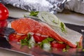 Salmon steak with tomatoes and onions for baking in aluminum foil Royalty Free Stock Photo