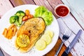 Salmon steak on wooden plate