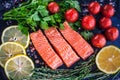 Salmon steakes with greenery, lemon and cherry tomatoes