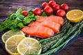salmon steakes with greenery, lemon and cherry tomatoes