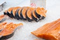 Salmon steaks and fillet lying on ice counter at fish market in Athens, Greece. Open shelf at seafood market. Close up Royalty Free Stock Photo