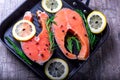 Salmon steaks in a grill pan with lemon, herbs and spices Royalty Free Stock Photo