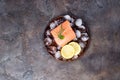 Salmon steaks on ice with lemon slice on wooden plate. Lean proteins. Royalty Free Stock Photo