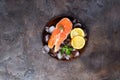 Salmon steaks on ice withlemon slice on wooden plate Royalty Free Stock Photo