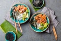 Salmon sushi bowl or salmon poce with soy sauce. Top view. Gray slate background Royalty Free Stock Photo