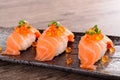 Salmon sushi with caviar on black plate Royalty Free Stock Photo