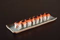 Salmon sushi roll aligned on plate Royalty Free Stock Photo
