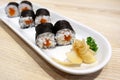 Salmon Sushi rolls with seaweed or Maki Sushi on white ceramic plate Royalty Free Stock Photo