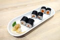 Salmon Sushi rolls with seaweed or Maki Sushi on white ceramic plate Royalty Free Stock Photo