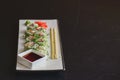 Salmon sushi rolls served on a white plate with ginger and wasabi and soy sauce in a restaurant table. Japanese cuisine. Royalty Free Stock Photo