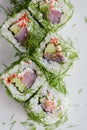 Salmon sushi rolls served on a white plate with ginger and wasabi and soy sauce in a restaurant table. Japanese cuisine. Royalty Free Stock Photo