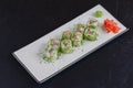 Salmon sushi rolls served on a white plate with ginger and wasabi and soy sauce in a restaurant table. Japanese cuisine. Royalty Free Stock Photo