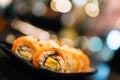 Salmon sushi or salmon roll, beautiful blur bokeh background, depth of field effect