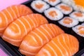 Salmon sushi and sashimi nigiri and maki roll closeup. Delicious japanese food with fresh fish, restaurant delivery set Royalty Free Stock Photo