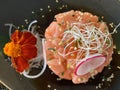 Salmon tartar with radish and seeds.