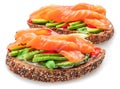 Salmon toasts with avocado isolated on white background. Top view Royalty Free Stock Photo