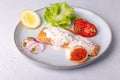 Salmon trout with creamy Champagne sauce with red caviar, salad, tomatoes, radish and lemon. Traditional French dish.