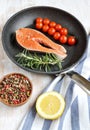 Salmon Trout Fillet on Pan Cooking Raw Fish Pepper Salt Rosemary Tomato Cherry Lemon Royalty Free Stock Photo