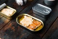 Salmon, tuna, trout mackerel and anchovy - Canned fish in tin cans, on old dark  wooden table background., with copyspace  and Royalty Free Stock Photo