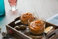 Salmorejo in crystal glasses, in a wooden tray