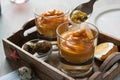 Salmorejo in crystal glasses, in a wooden tray