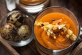 Salmorejo in crystal glasses, in a wooden tray