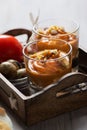 Salmorejo in crystal glasses, in a wooden tray