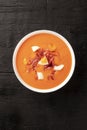 Salmorejo, Spanish chilled tomato soup, shot from the top on a black background