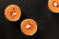 Salmorejo, Spanish cold tomato and bread soup, in glasses, shot from the top on a black background