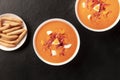 Salmorejo, Spanish cold tomato soup, overhead shot on a black background