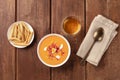 Salmorejo, Spanish cold tomato soup, top shot on a rustic background with wine