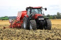 Red Case IH Tractor and Seeder on Field