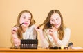 Salon and beauty treatment. Just like playing with makeup. Children little girls choose cosmetics. Makeup store