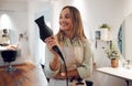 Salon, hairdresser and woman with hairdryer for professional styling thinking and holding equipment. Smile of happy hair