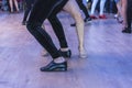 Salsa dance performers on a dance floor, indoor, feet details, close up