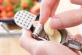 Male hands put the cloves of garlic in a garlic press or juicer Royalty Free Stock Photo