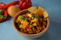 Salsa with mango, herbs, onions and peppers, corn chips close up in a bowl. Royalty Free Stock Photo