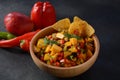 Salsa with mango, herbs, onions and peppers, corn chips close up in a bowl. Royalty Free Stock Photo