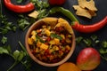 Salsa with mango, herbs, onions and peppers, corn chips close up in a bowl. Royalty Free Stock Photo