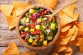 salsa with mangoes, peppers, cilantro and onion closeup and nachos. horizontal top view Royalty Free Stock Photo