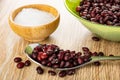 Salt in bowl, bean in bowl, red bean in spoon on wooden table