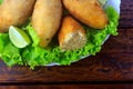 Salt cod fritter, bacalao bunuelos over rustic wooden restaurant table Royalty Free Stock Photo