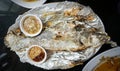 Salt-crusted grilled fish with spicy sacue Royalty Free Stock Photo