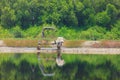 Salt farmers with car roller. Royalty Free Stock Photo