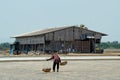 Salt farmers carry salt into the shed