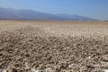 The salt flats at Badwater Basin, backed by stark mountains, on a hazy day in Death Valley National Park, California Royalty Free Stock Photo