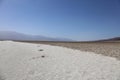 The salt flats at Badwater Basin stretching out to the horizon with mountains in the distance, in Death Valley National Park Royalty Free Stock Photo