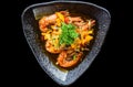 Salt fried shrimp with sauce and vegetables isolated on black backround